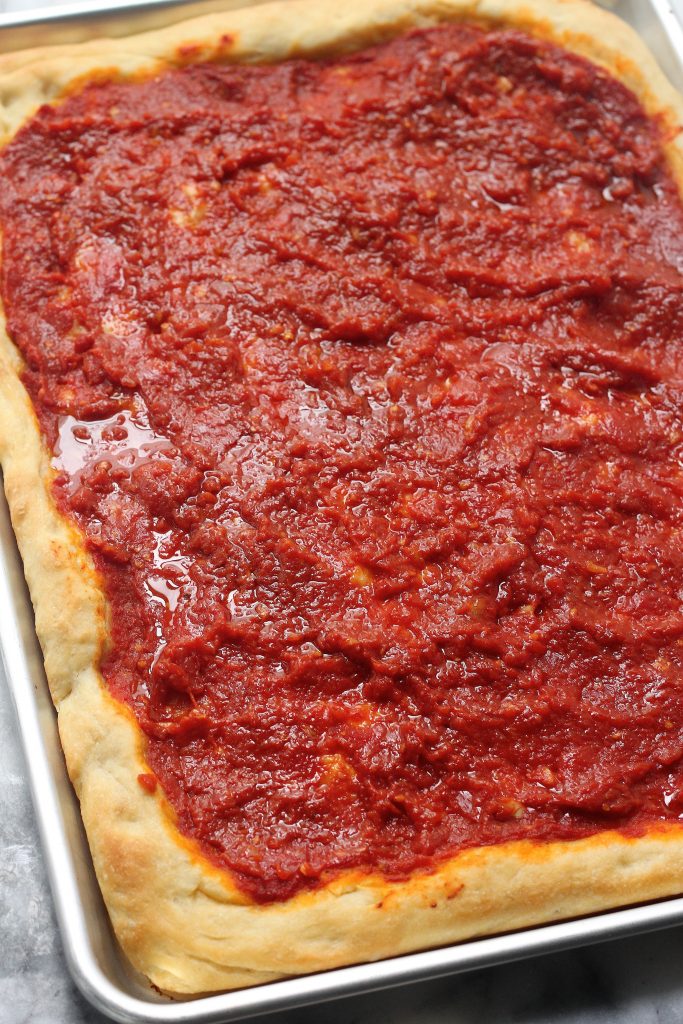 Tomato Pie in baking pan on marble counter.
