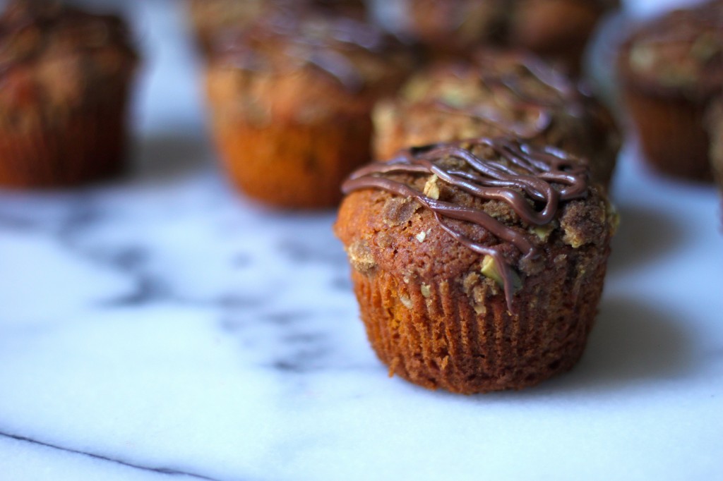 Pumpkin Banana Olive Oil Muffins with Crystalized Ginger Pepita Crumble and Nutella Drizzle