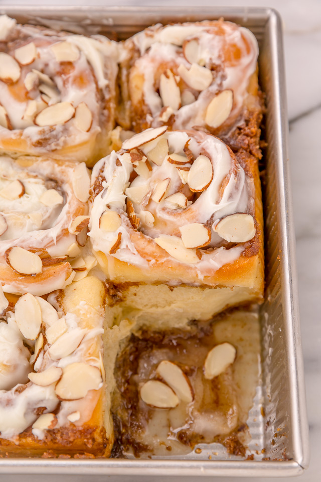 Triple Almond Cinnamon Rolls are the ultimate breakfast treat! This indulgent recipe features soft and fluffy yeasted buns that are filled with brown sugar cinnamon filling and topped with a sticky sweet glaze and slivered almonds! This homemade almond cinnamon roll recipe is a MUST for all of the almond lovers out there!