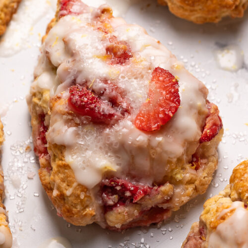 Fresh Strawberry Scones with Lemon Glaze are flaky and loaded with juicy strawberries! This is an easy breakfast the whole family will love! So good with a cup of tea or coffee!