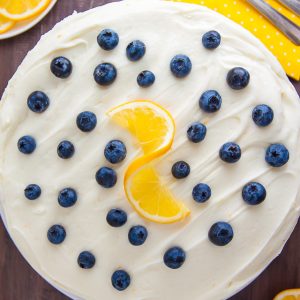 Supremely moist and flavorful Lemon Blueberry Cake slathered with homemade Lemon Frosting. This is the ULTIMATE Lemon Blueberry Cake!