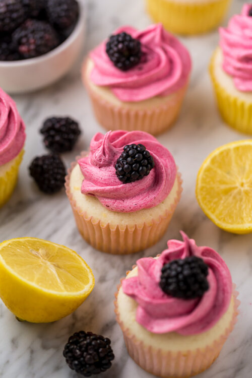 Fluffy Lemon Cupcakes are topped with BLACKBERRY Buttercream! These Lemon Blackberry Cupcakes are so pretty and always a showstopper. Their refreshing flavor makes them perfect for Spring and Summer celebrations! 