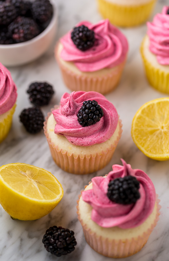 Fluffy Lemon Cupcakes are topped with BLACKBERRY Buttercream! These Lemon Blackberry Cupcakes are so pretty and always a showstopper. Their refreshing flavor makes them perfect for Spring and Summer celebrations!