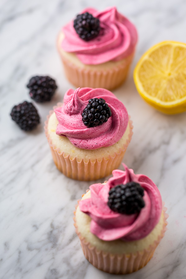 Fluffy Lemon Cupcakes are topped with BLACKBERRY Buttercream! These Lemon Blackberry Cupcakes are so pretty and always a showstopper. Their refreshing flavor makes them perfect for Spring and Summer celebrations!