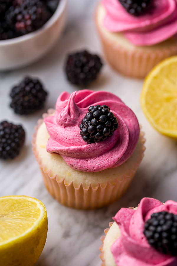 Fluffy Lemon Cupcakes are topped with BLACKBERRY Buttercream! These Lemon Blackberry Cupcakes are so pretty and always a showstopper. Their refreshing flavor makes them perfect for Spring and Summer celebrations!