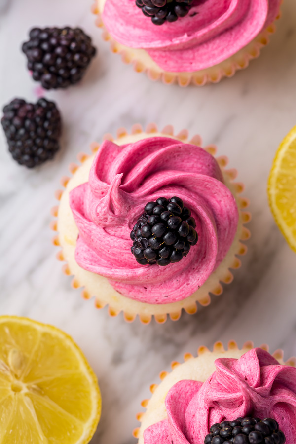 Fluffy Lemon Cupcakes are topped with BLACKBERRY Buttercream! These Lemon Blackberry Cupcakes are so pretty and always a showstopper. Their refreshing flavor makes them perfect for Spring and Summer celebrations!