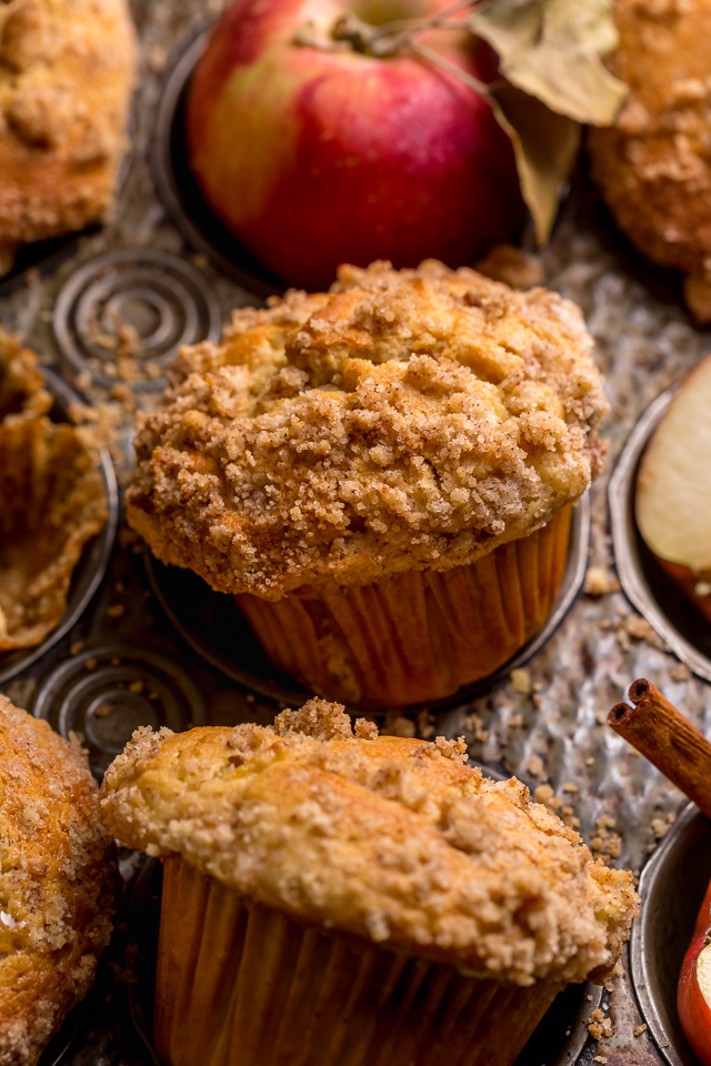 Apple muffins in paper liners in the muffin pan.