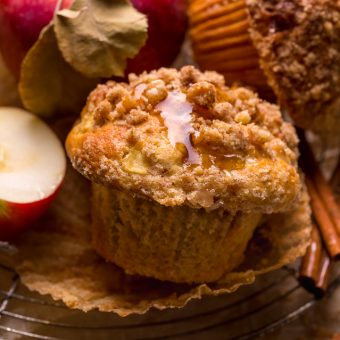Apple muffins on a cooling rack with pink lady apples.