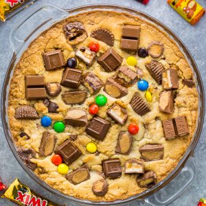 This easy to make Halloween Candy Cookie Cake is the perfect way to use up leftover candy! A hit with kids and adults!