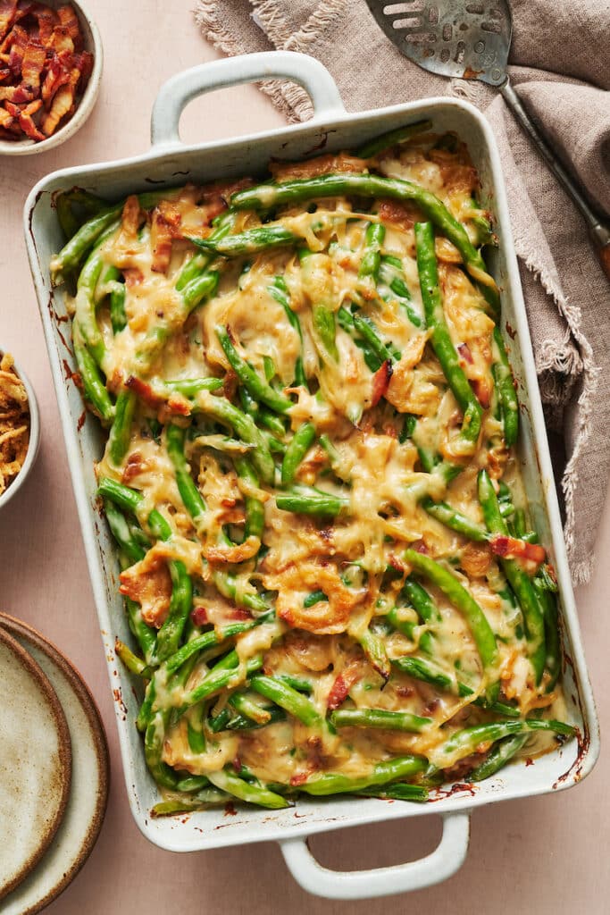 Baked green bean casserole in baking dish on table.