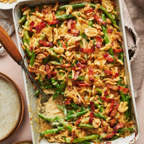 Baking dish with green bean casserole topped with crispy fried onions.