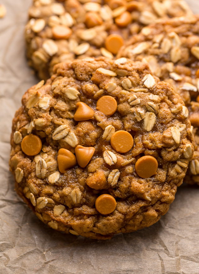 Butterscotch oatmeal cookies on a baking sheet with butterscotch chips on top.