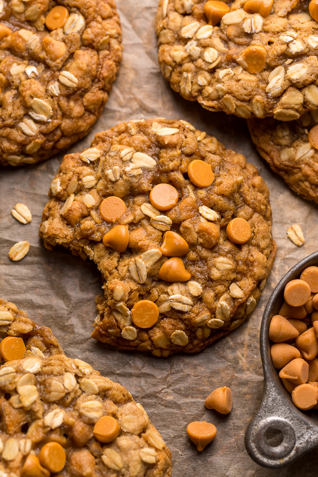 Butterscotch oatmeal cookies on a baking sheet with butterscotch chips on top.