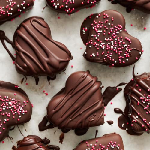 Chocolate covered peanut butter hearts with sprinkles on top.