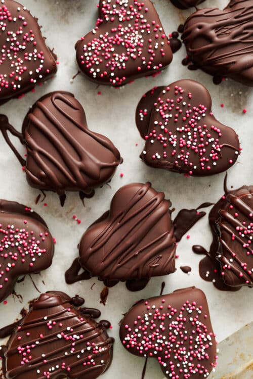 Chocolate covered peanut butter hearts with sprinkles on top.