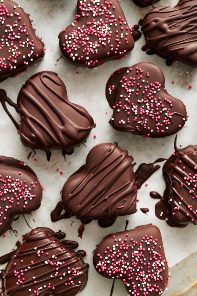 Chocolate covered peanut butter hearts with sprinkles on top.