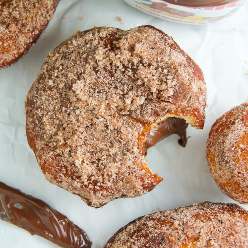 Homemade Cinnamon Sugar Doughnuts stuffed with a dollop of creamy Nutella. The definition of decadence!