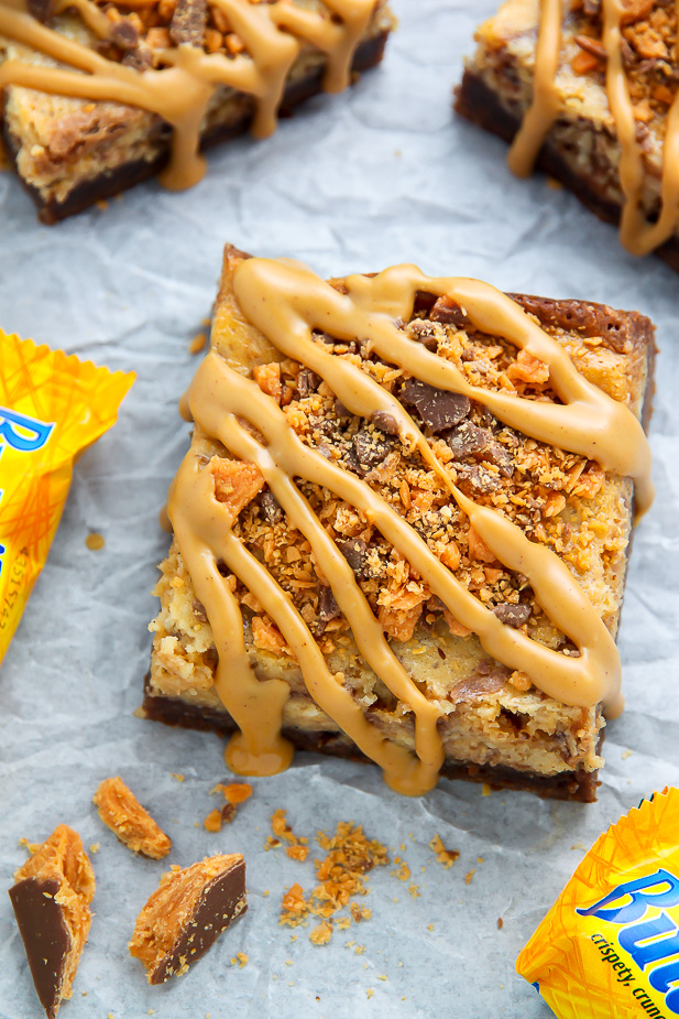 If the thought of Creamy Butterfinger Finger Cheesecake Brownies drizzled with peanut butter glaze makes you weak at the knees, this post is going to rock your life.