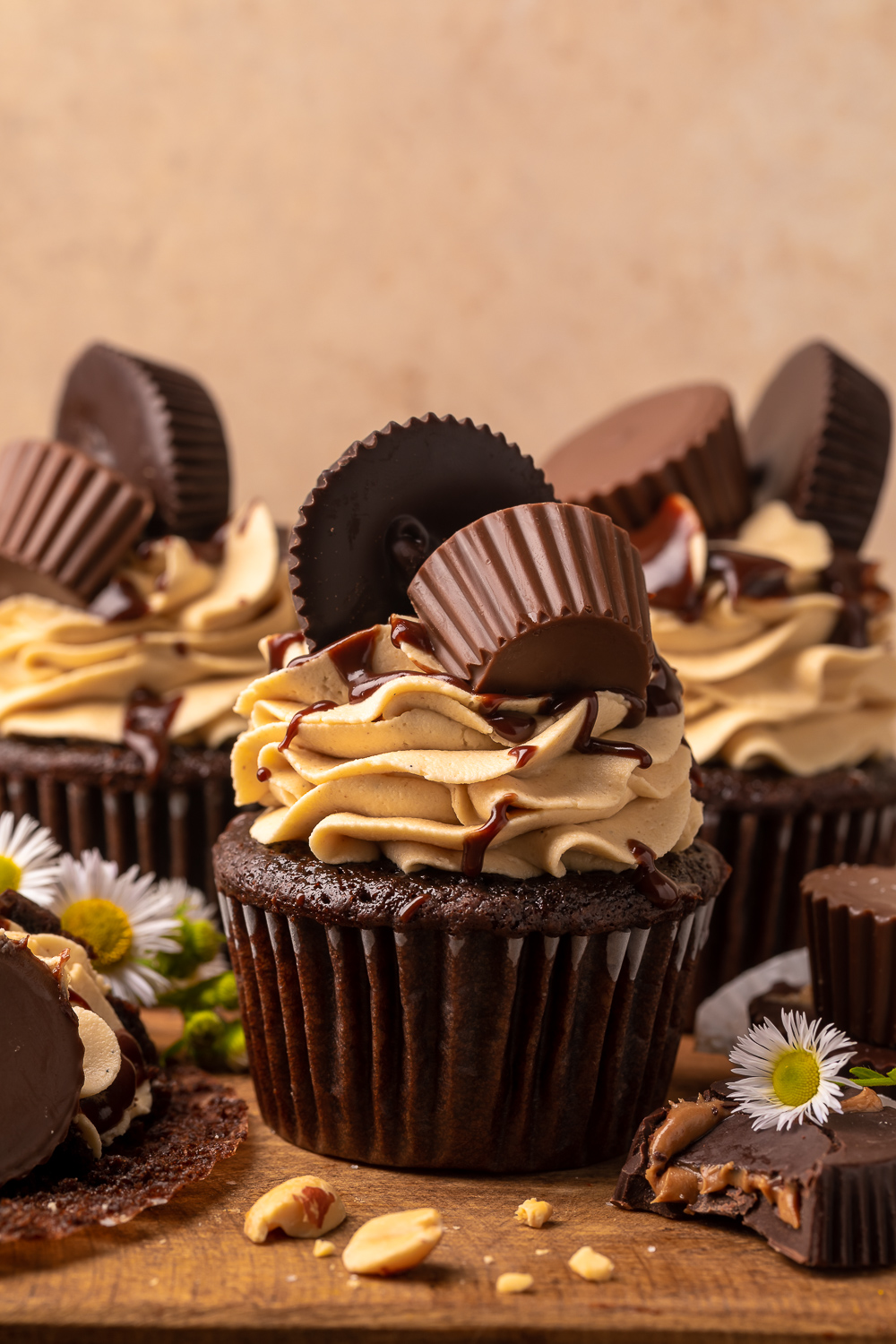 Have a peanut butter lover in your life? You have to bake them these Ultimate Chocolate Peanut Butter Cupcakes!  Featuring moist chocolate cupcakes that are stuffed with a peanut butter cup, topped with peanut butter frosting, milk chocolate peanut butter ganache, and chopped peanuts, these are always a crowd-pleaser!