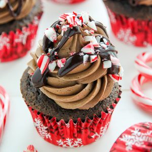 Supremely moist and decadent chocolate cupcakes topped with peppermint mocha frosting, a drizzle of chocolate ganache, and crushed candy canes.