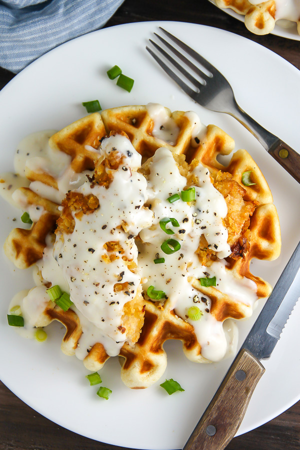 Fluffy buttermilk waffles topped with crispy "oven-fried" chicken and creamy white pepper gravy. Brunch perfection.