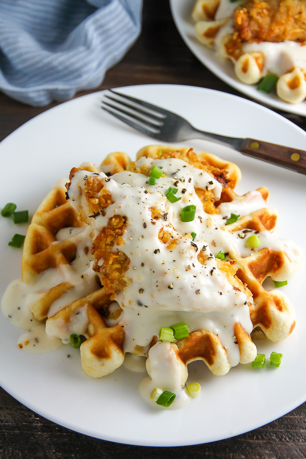 Fluffy buttermilk waffles topped with crispy "oven-fried" chicken and creamy white pepper gravy. Brunch perfection.