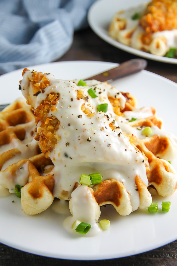 Fluffy buttermilk waffles topped with crispy "oven-fried" chicken and creamy white pepper gravy. Brunch perfection.