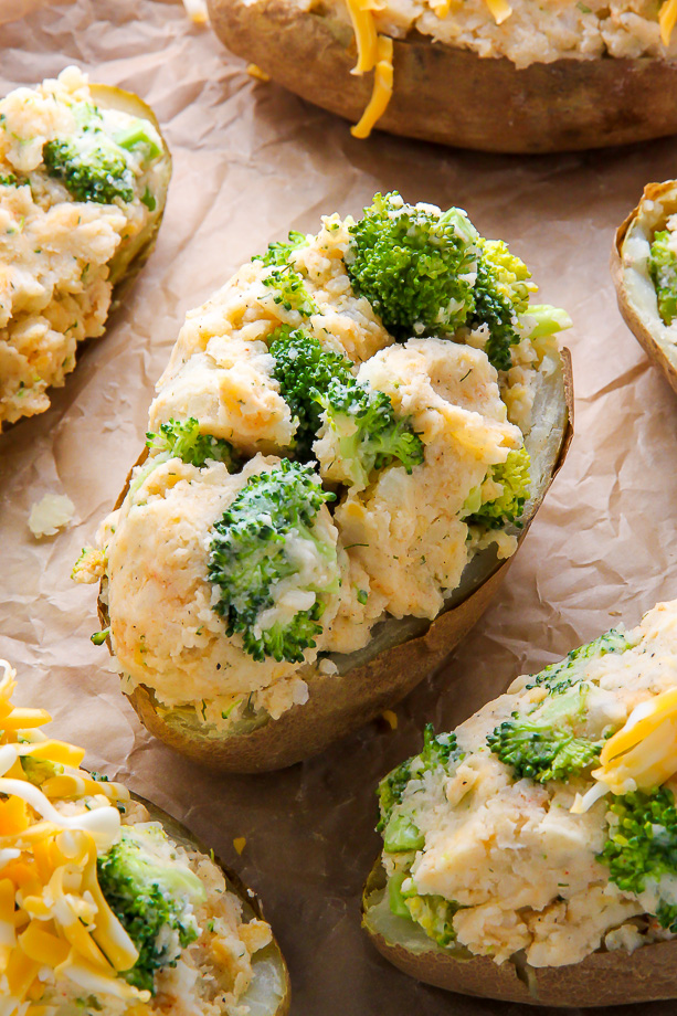 Twice baked potatoes topped with broccoli and cheese.