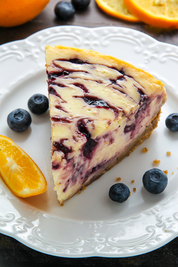 Supremely smooth and creamy homemade Lemon cheesecake topped with fresh Blueberry swirls. All layered on top of a buttery homemade graham cracker crust.