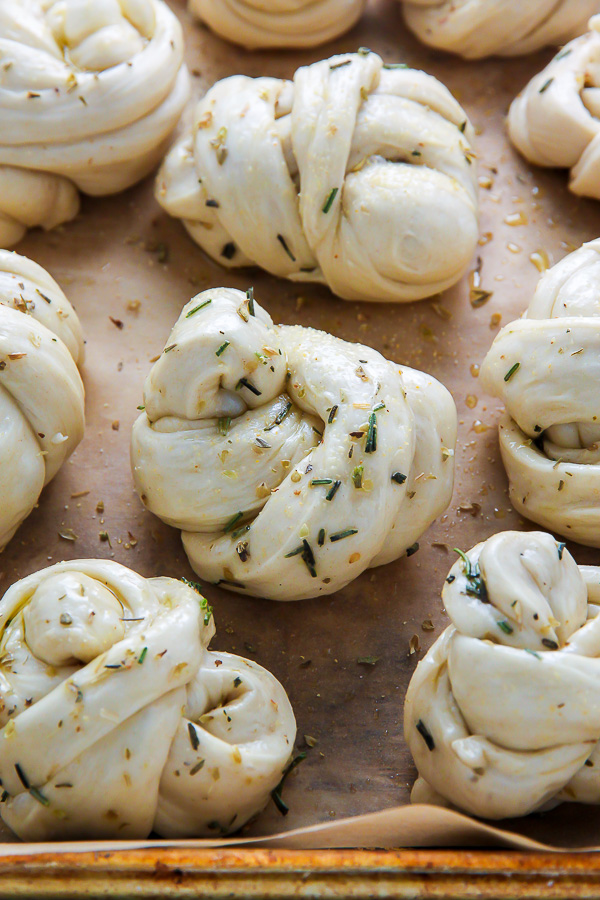 Garlic knot homemade dough shaped and ready to be baked on a baking sheet.
