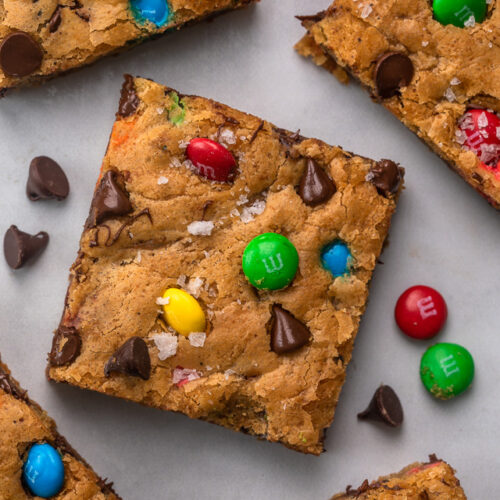These thick and chewy Brown Butter M&M Blondies are irresistible! An easy cookie bar that's loaded with chocolate chips and M&M candies. Loved by kids and adults, this blondie recipe is always a crowd pleaser!