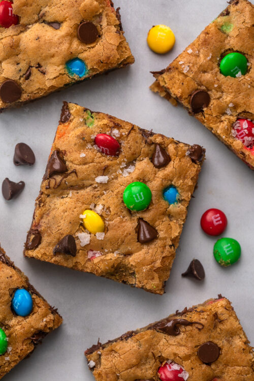 These thick and chewy Brown Butter M&M Blondies are irresistible! An easy cookie bar that's loaded with chocolate chips and M&M candies. Loved by kids and adults, this blondie recipe is always a crowd pleaser!