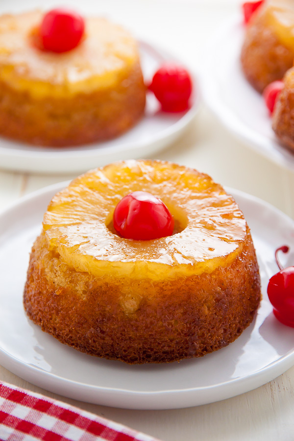 Mini Pineapple Upside-Down Cakes on white plates.