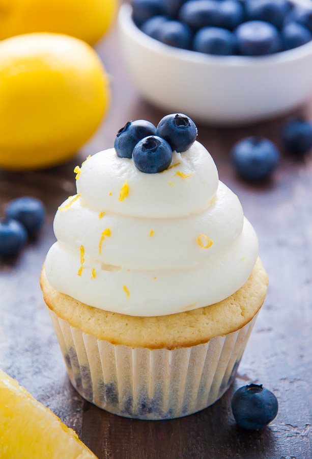 Homemade Lemon Blueberry Cupcakes are topped with luscious Lemon Cream Cheese Frosting and Fresh Blueberries! The moist lemon cupcakes are so flavorful and bursting with juicy blueberries. This recipe is such a crowd-pleaser and perfect for Summer birthday parties, picnics, or barbecues!