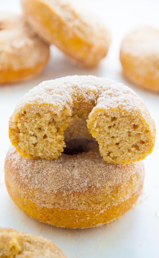 Baked cinnamon sugar donut on a white piece of parchment paper.