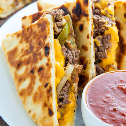 Philly Cheesesteak Quesadillas are loaded with meat, cheese, pepper, and onions! Serve with marinara sauce, ketchup, or sour cream.