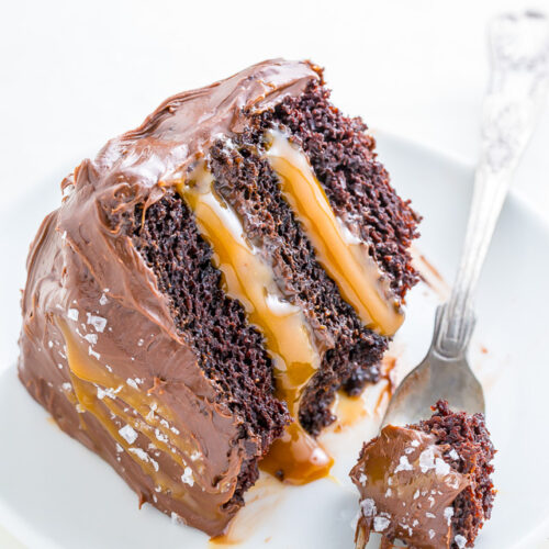 A slice of salted caramel chocolate cake on a plate.