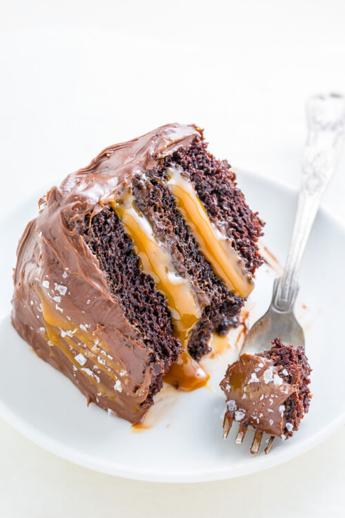 A slice of salted caramel chocolate cake on a plate.