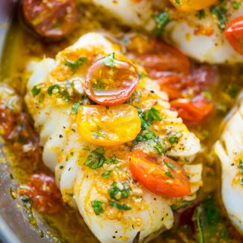 Cod fish cooked in a sauté pan and covered in tomato basil sauce.