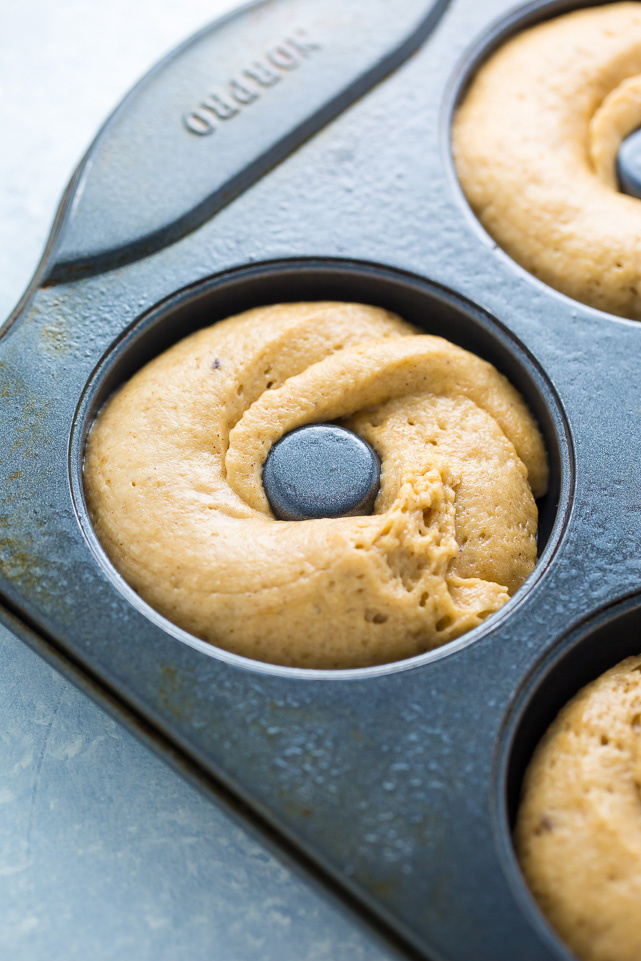 Donut batter piped into donut molds.