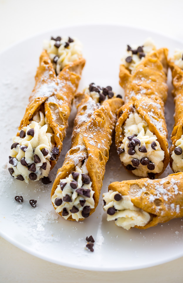 Cannoli with chocolate chips on a white plate.