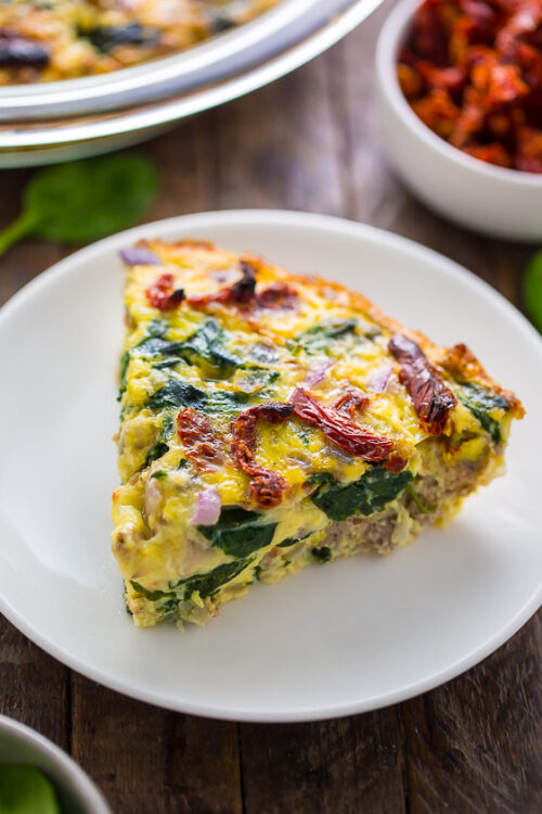 Slice of crustless quiche on a white plate.