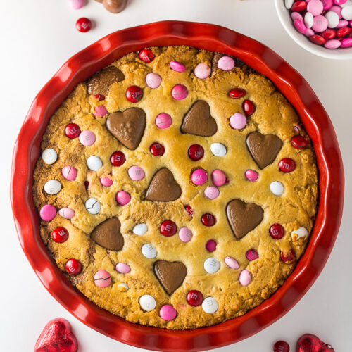 This deep dish Valentine's Day Cookie Pie is loaded with festive M&M's and Heart Shaped Peanut Butter Cups!