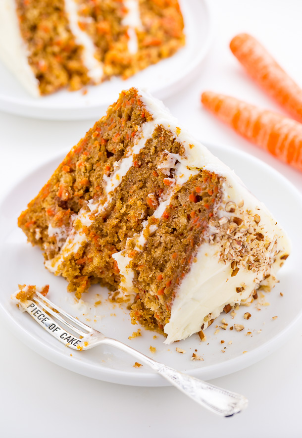 A slice of carrot cake with a few bites taken out of it.