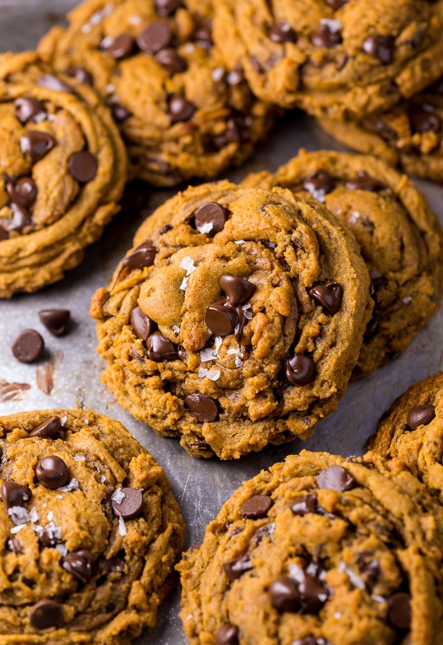 Pumpkin chocolate chip cookies on a baking sheet. 