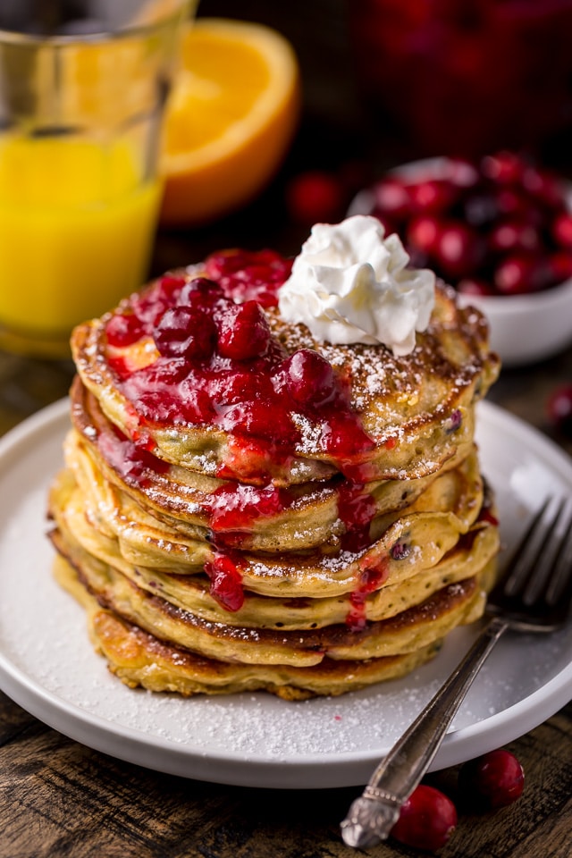 Fluffy and flavorful Cranberry Orange Pancakes are topped with Maple Cranberry Syrup!