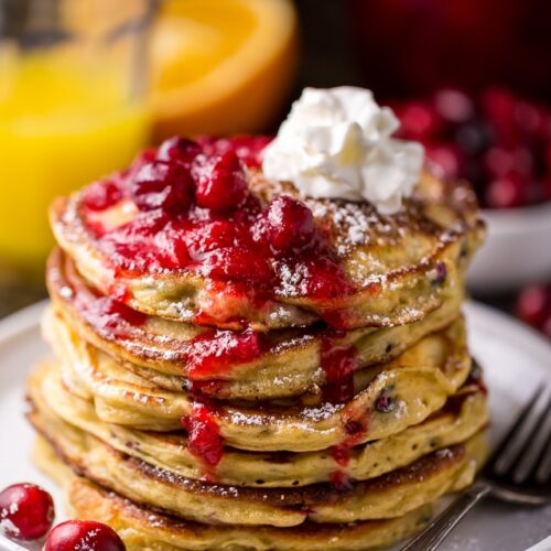 Fluffy and flavorful Cranberry Orange Pancakes are topped with Maple Cranberry Syrup!