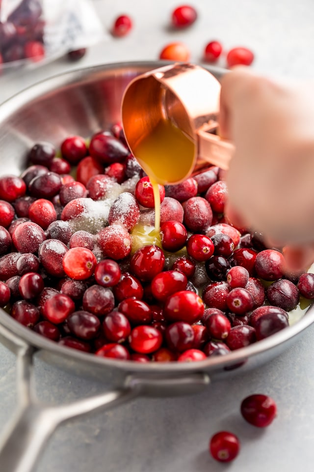 Fluffy and flavorful Cranberry Orange Pancakes are topped with Maple Cranberry Syrup!