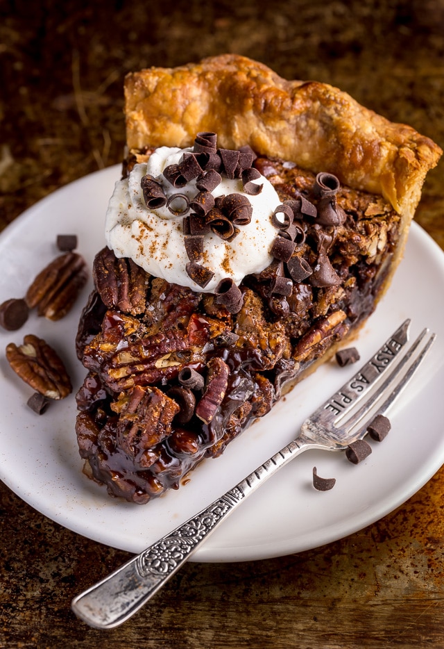 This insanely decadent Chocolate Pecan Pie is topped with a dollop of whipped cream... and extra chocolate, of course!