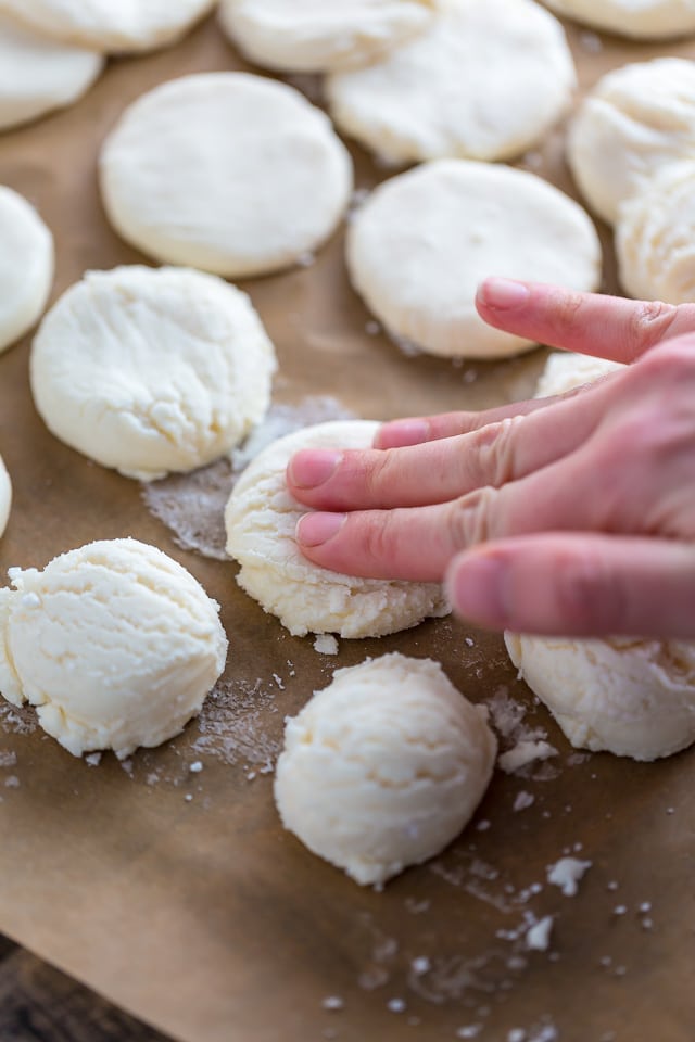 A hand flattening out the peppermint patty rounds.